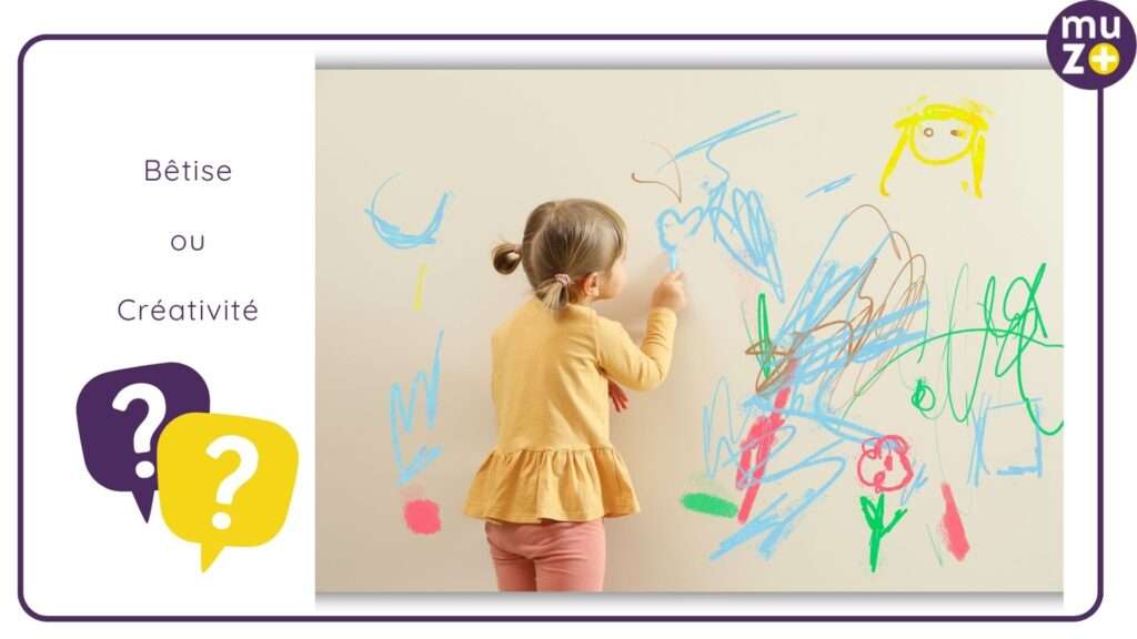 un enfant qui dessine sur un mur